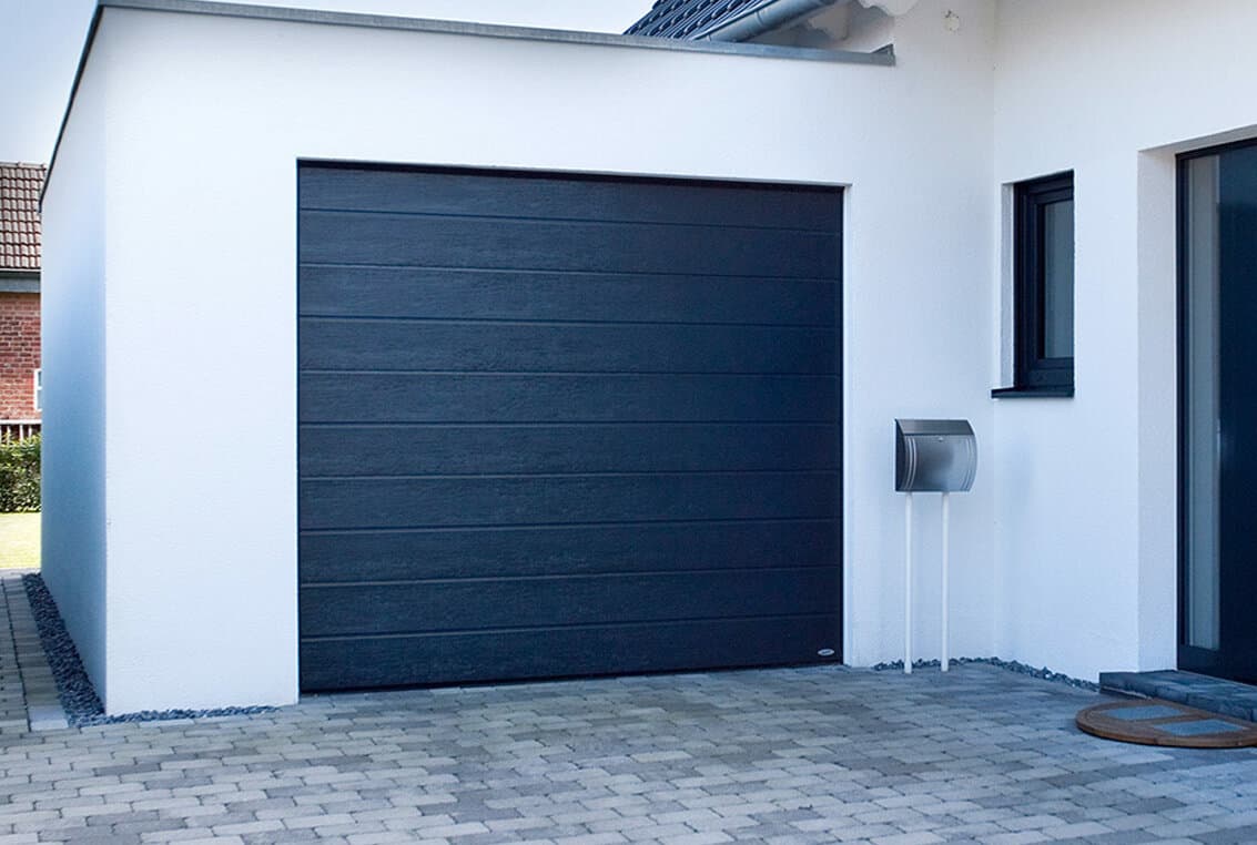 SBI sectional garage door installed on a family home